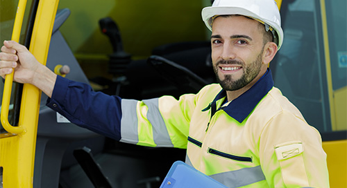 a man wearing a hard hat and a yellow jacket