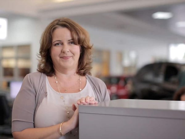 a woman standing next to a box