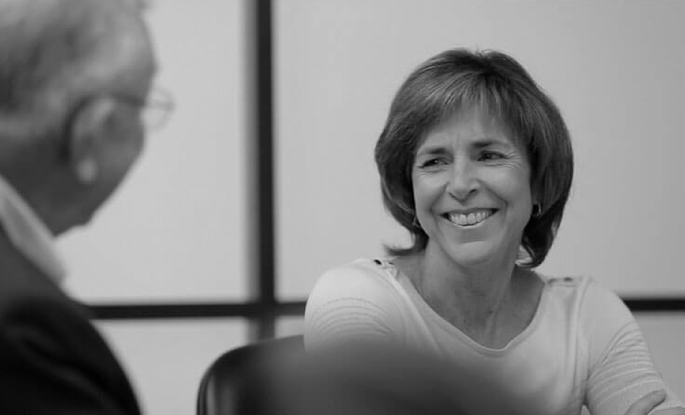 a woman smiling at another man