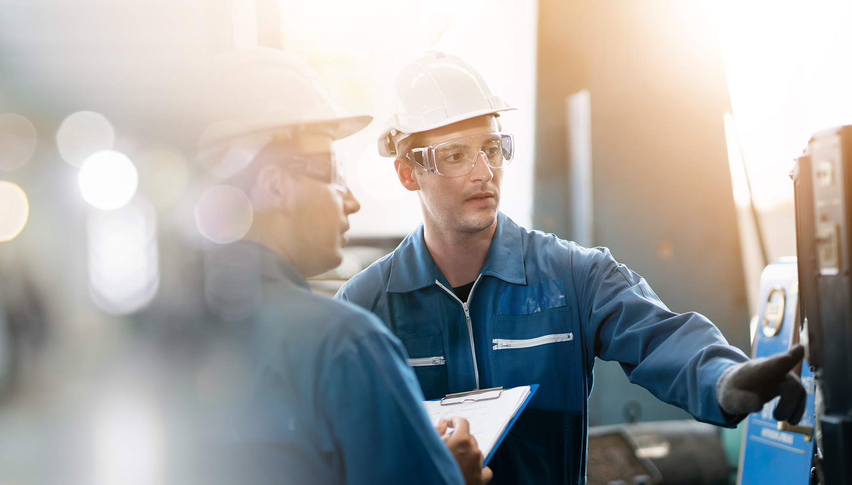 a group of men wearing hardhats and safety glasses