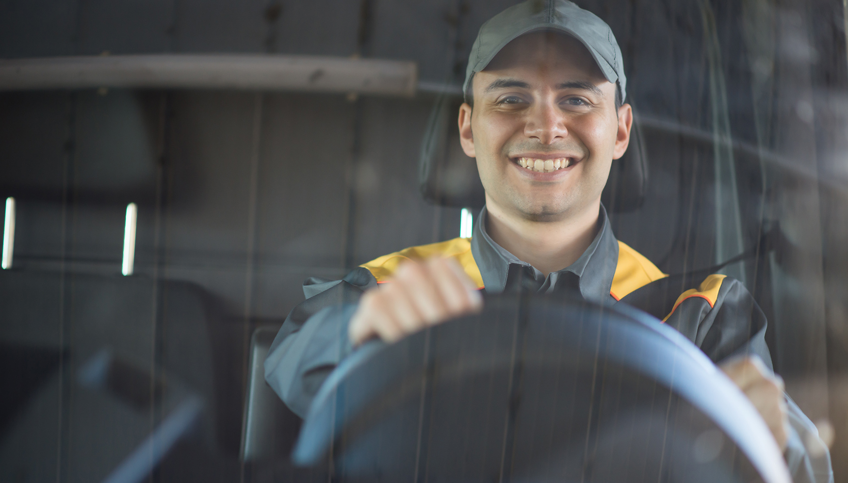 a man in a cap smiling at the camera