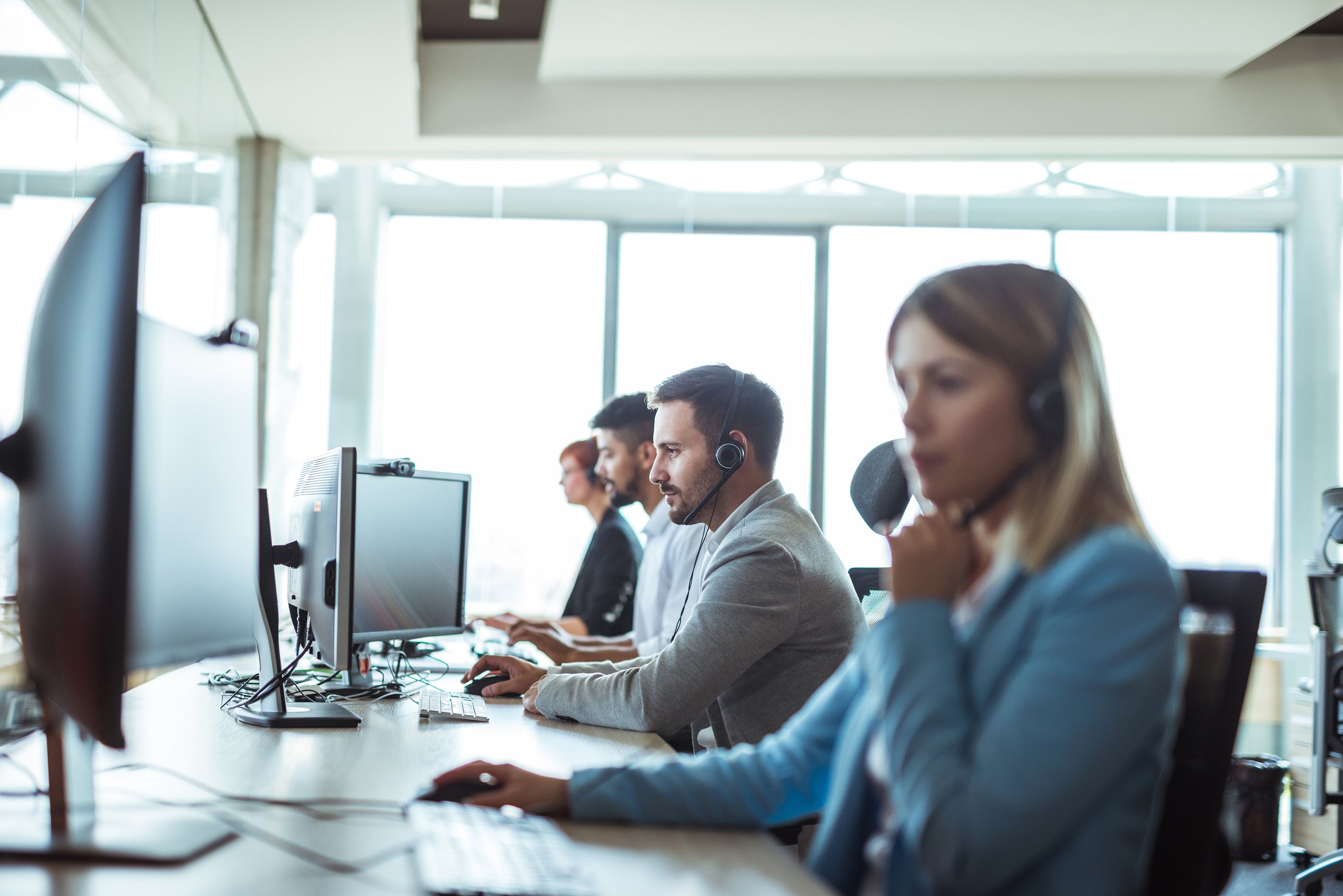 a group of people sitting at computers