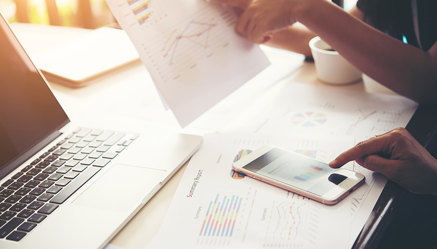 a person holding a phone and a paper