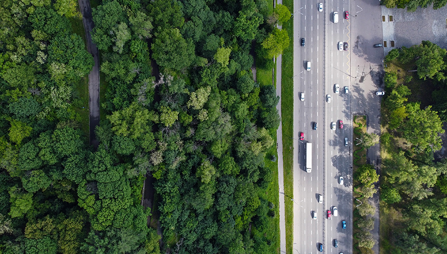 a highway with many cars and trees