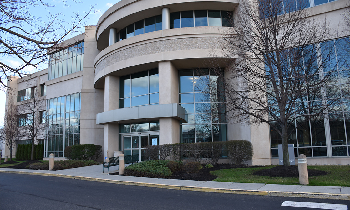 a building with a curved front door