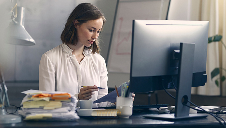 a woman looking at a piece of paper
