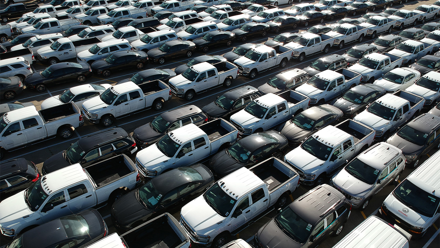 a large group of cars parked in a parking lot