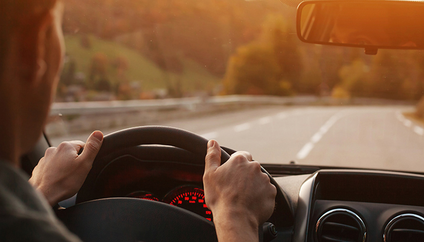hands on the steering wheel of a car