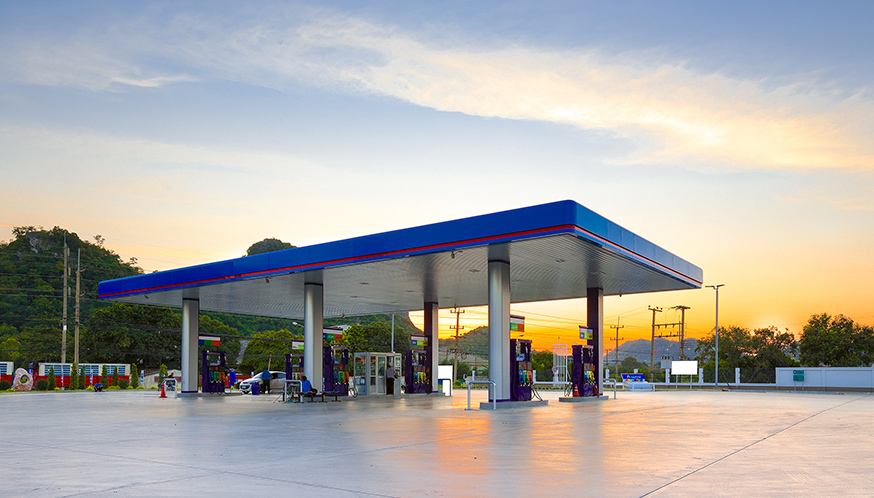 a gas station with a blue roof