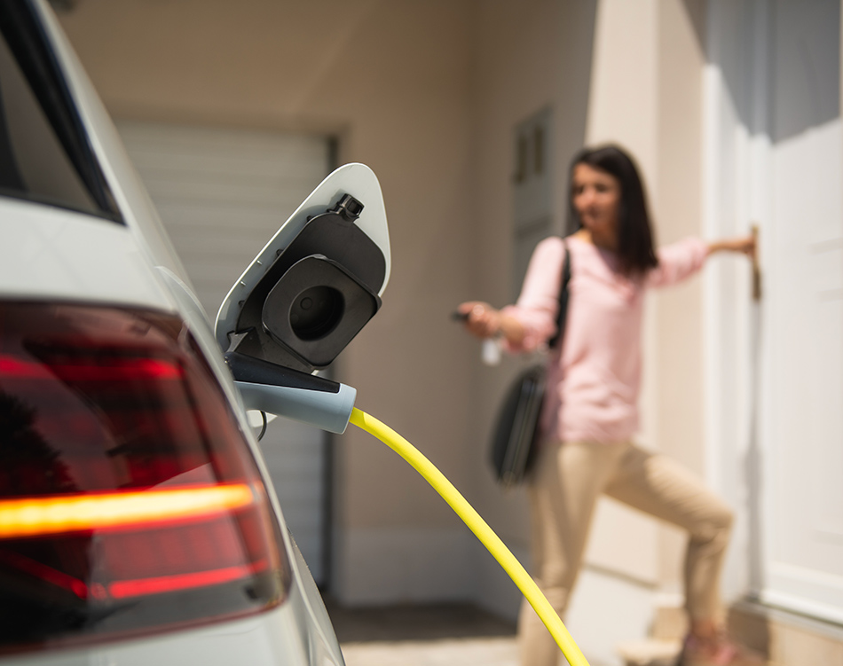 a woman standing next to a car