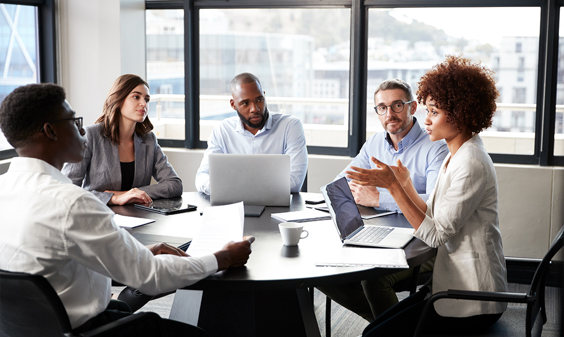 a group of people sitting around a round table