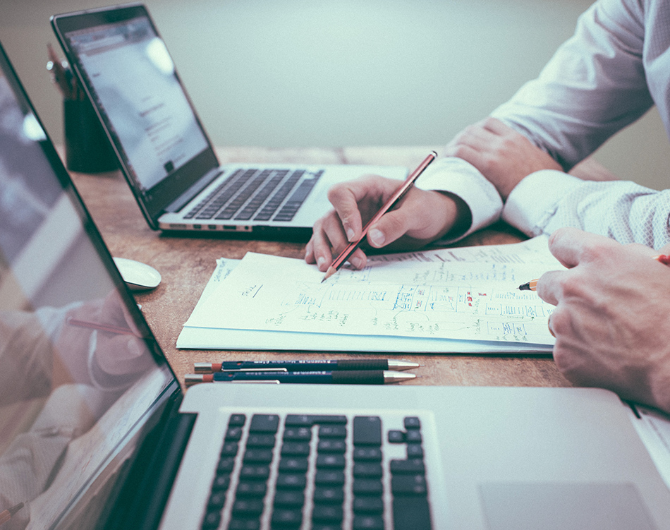 a man holding a pen and writing on a piece of paper
