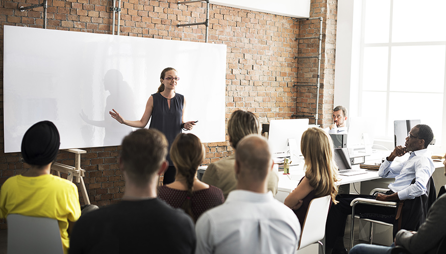 a woman standing in front of a group of people