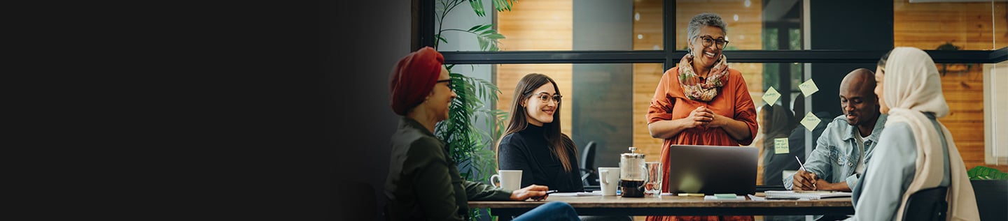 a woman sitting at a table with a woman smiling