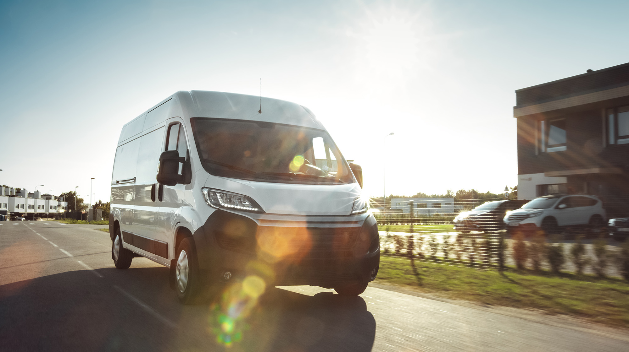 a white van driving on the road