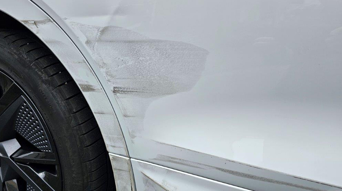 a white car with a scratch on the side