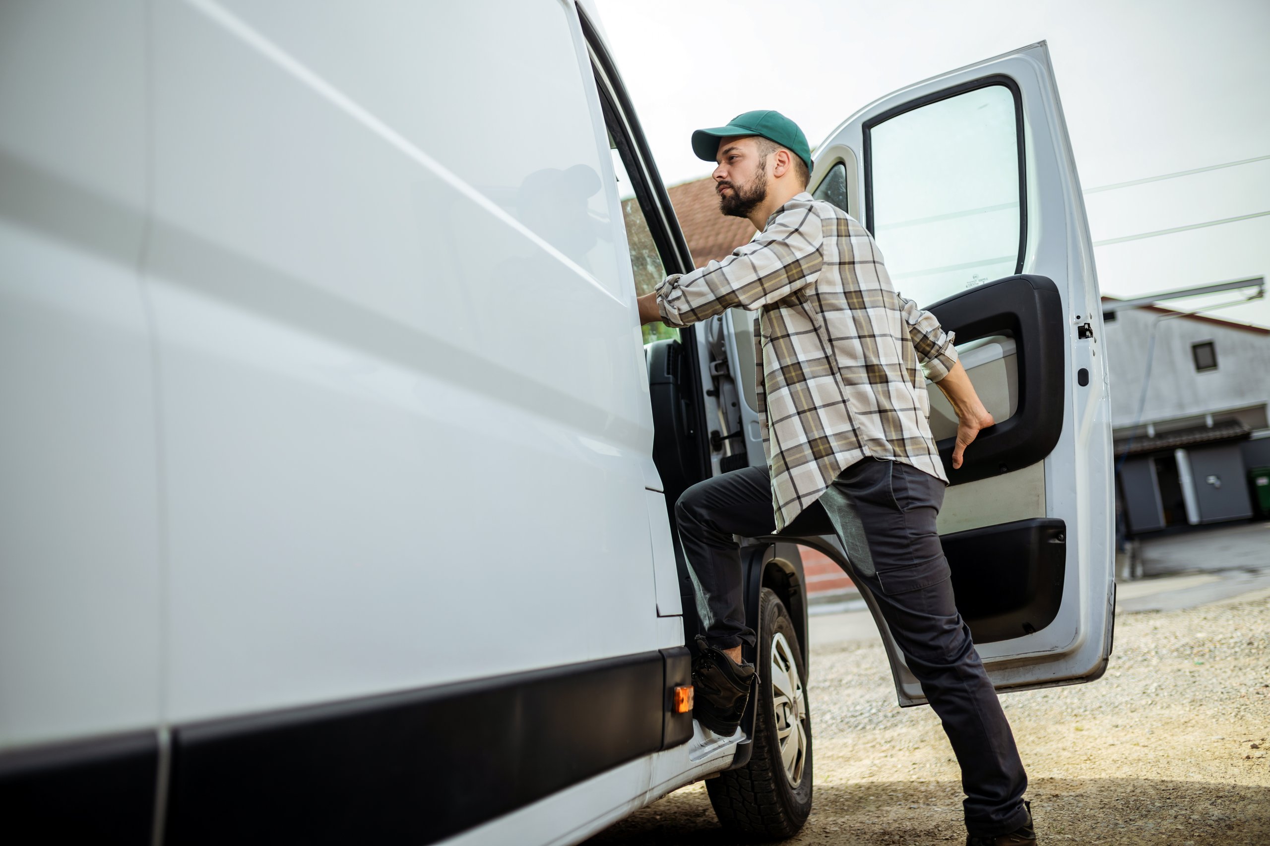 a man climbing out of a van