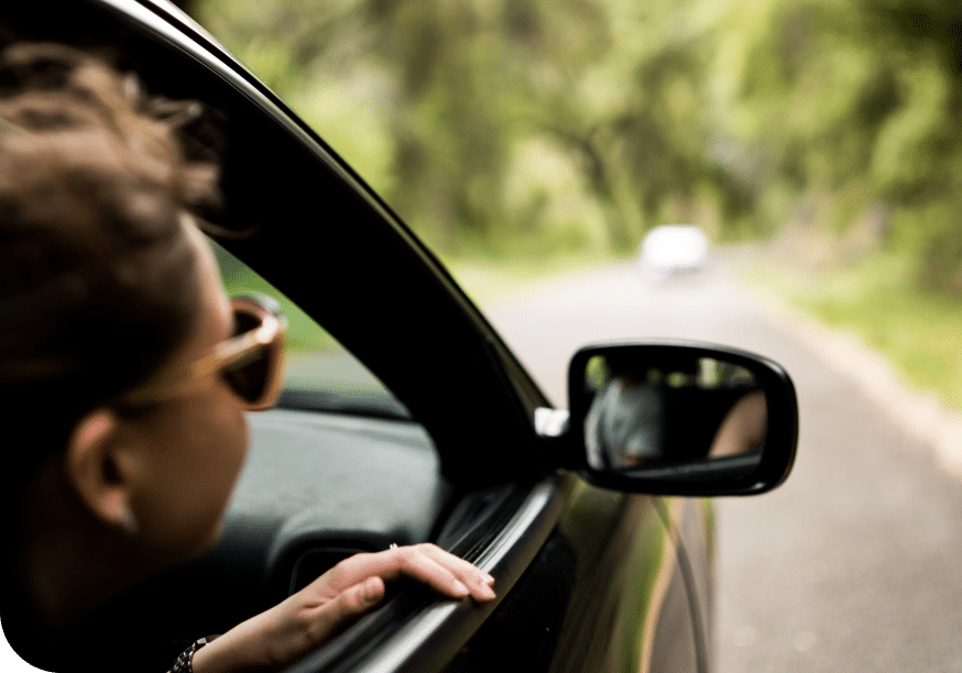 a woman looking out of a car window