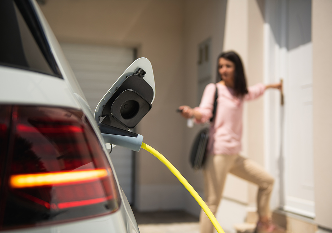 a woman standing in front of a car