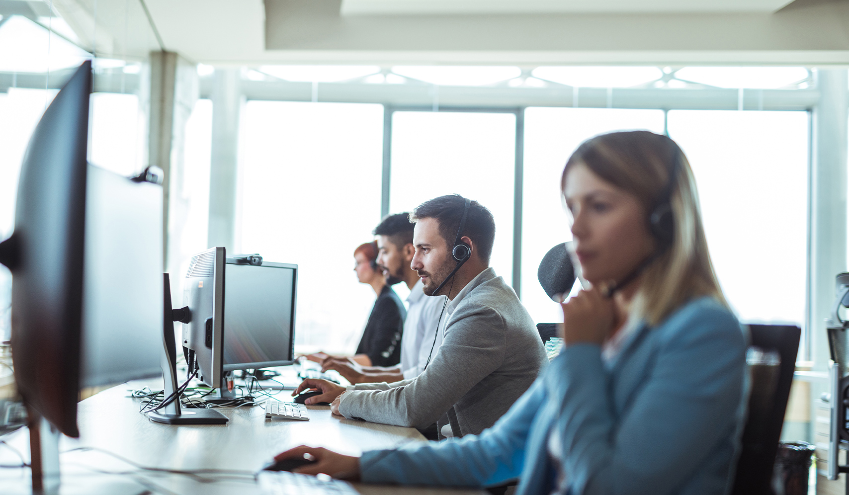 a group of people sitting at computers