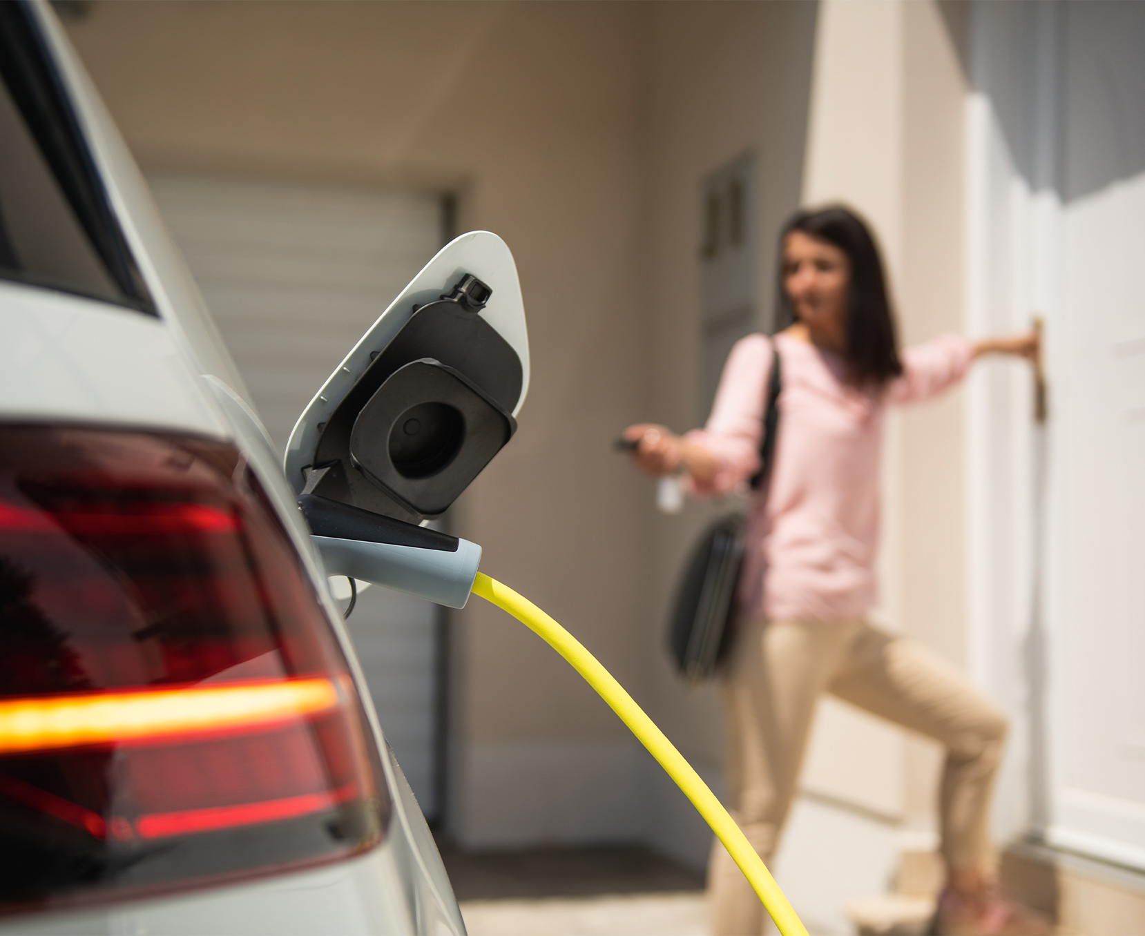 a woman standing next to a car