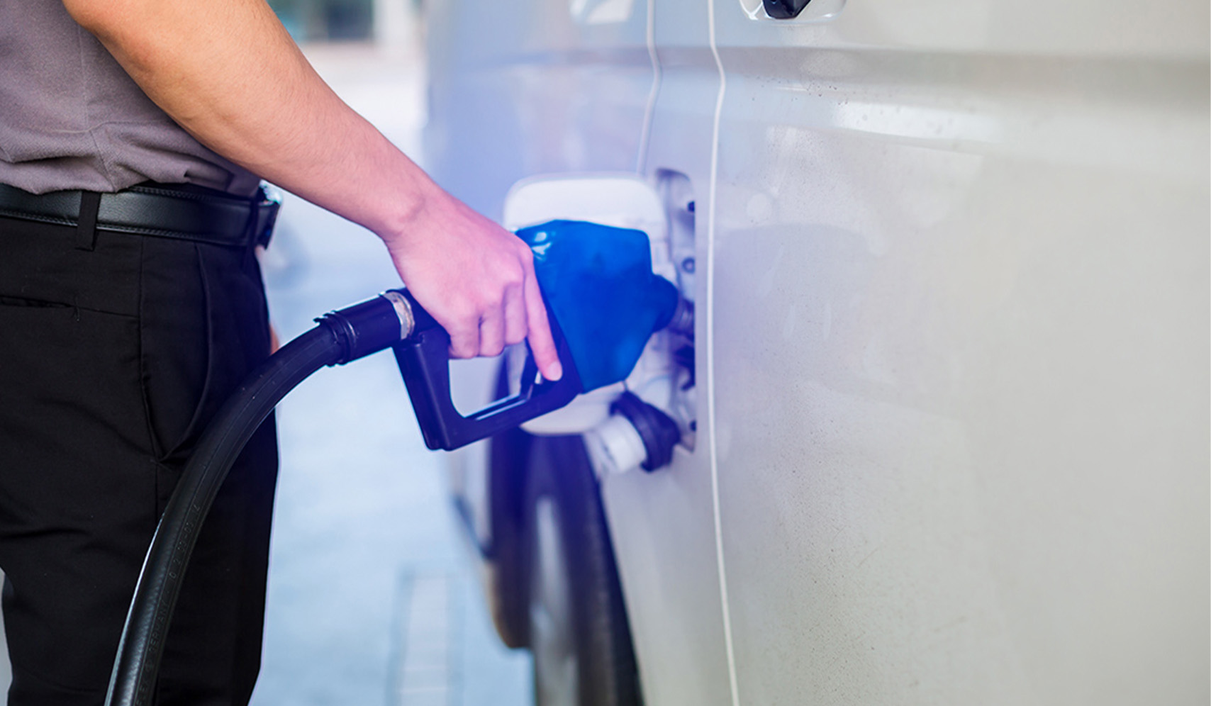 a person holding a gas pump