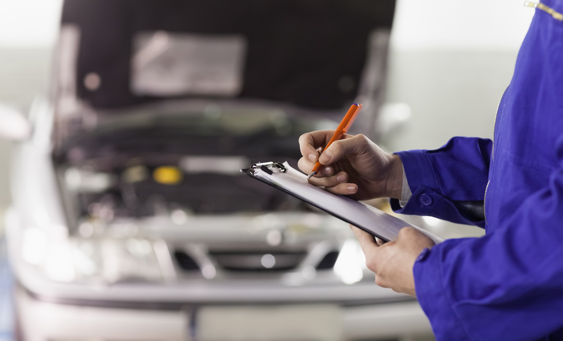 a person writing on a clipboard