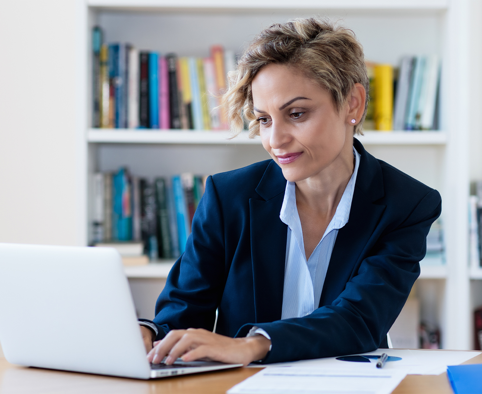 a woman in a suit using a laptop