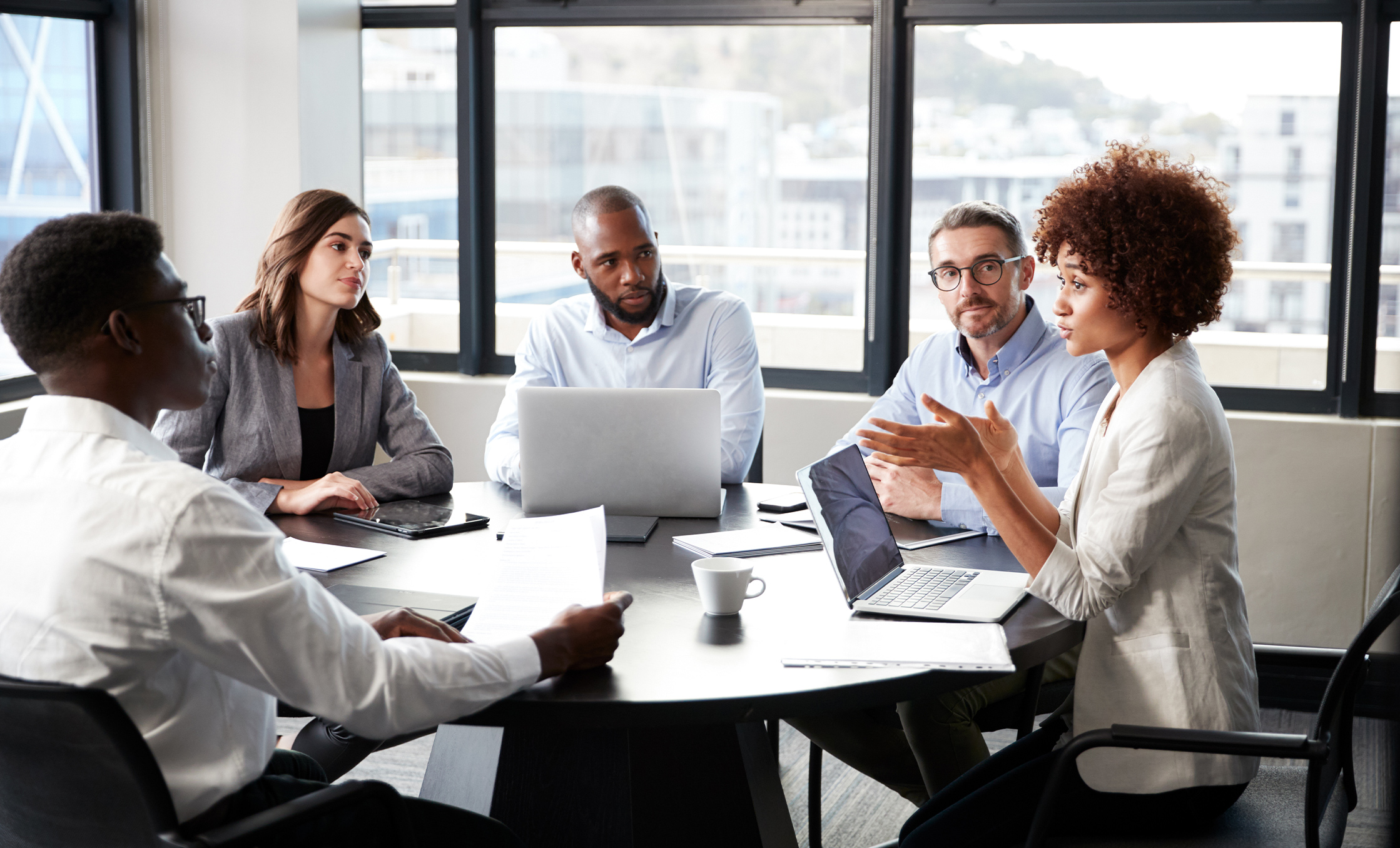 a group of people sitting around a round table