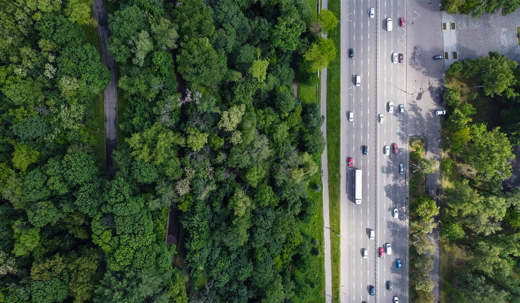 aerial view of a highway with many cars and trees