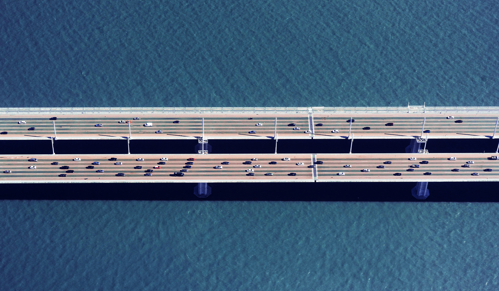 a bridge over water with cars
