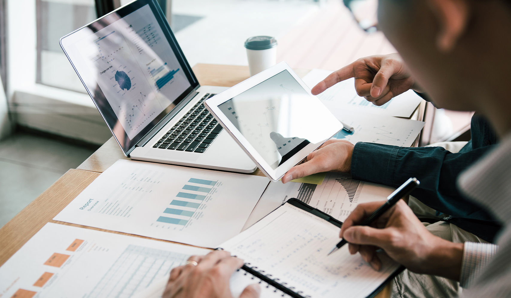 a group of people looking at a tablet