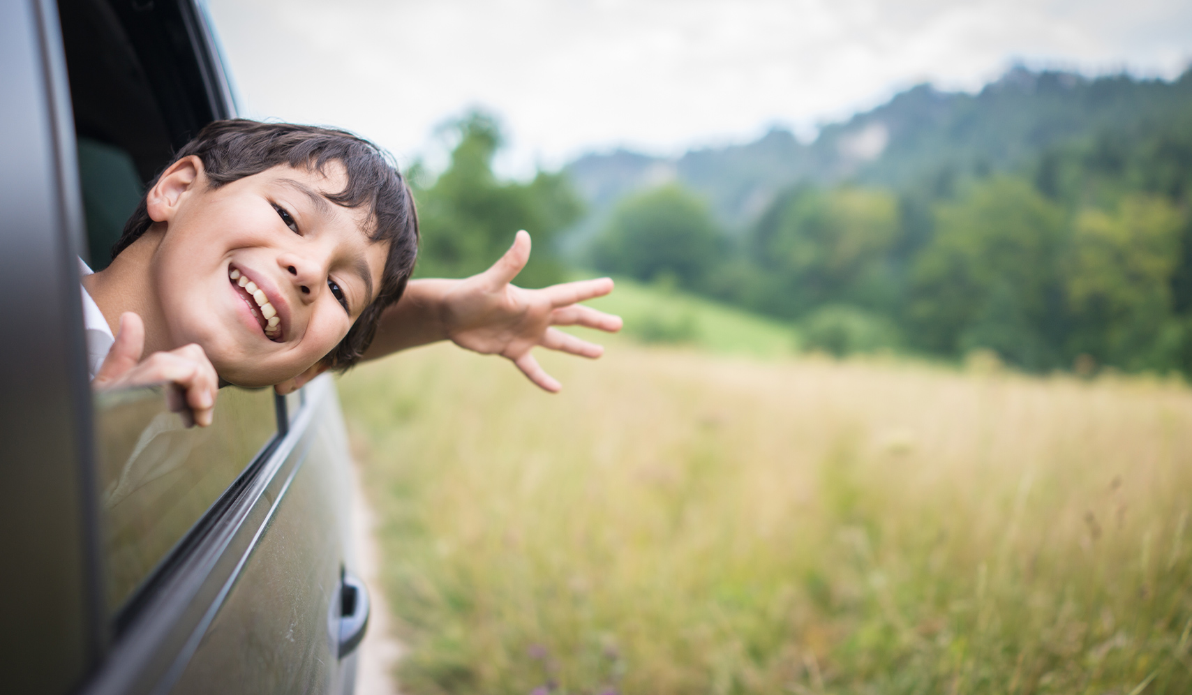 a boy looking out of a car window