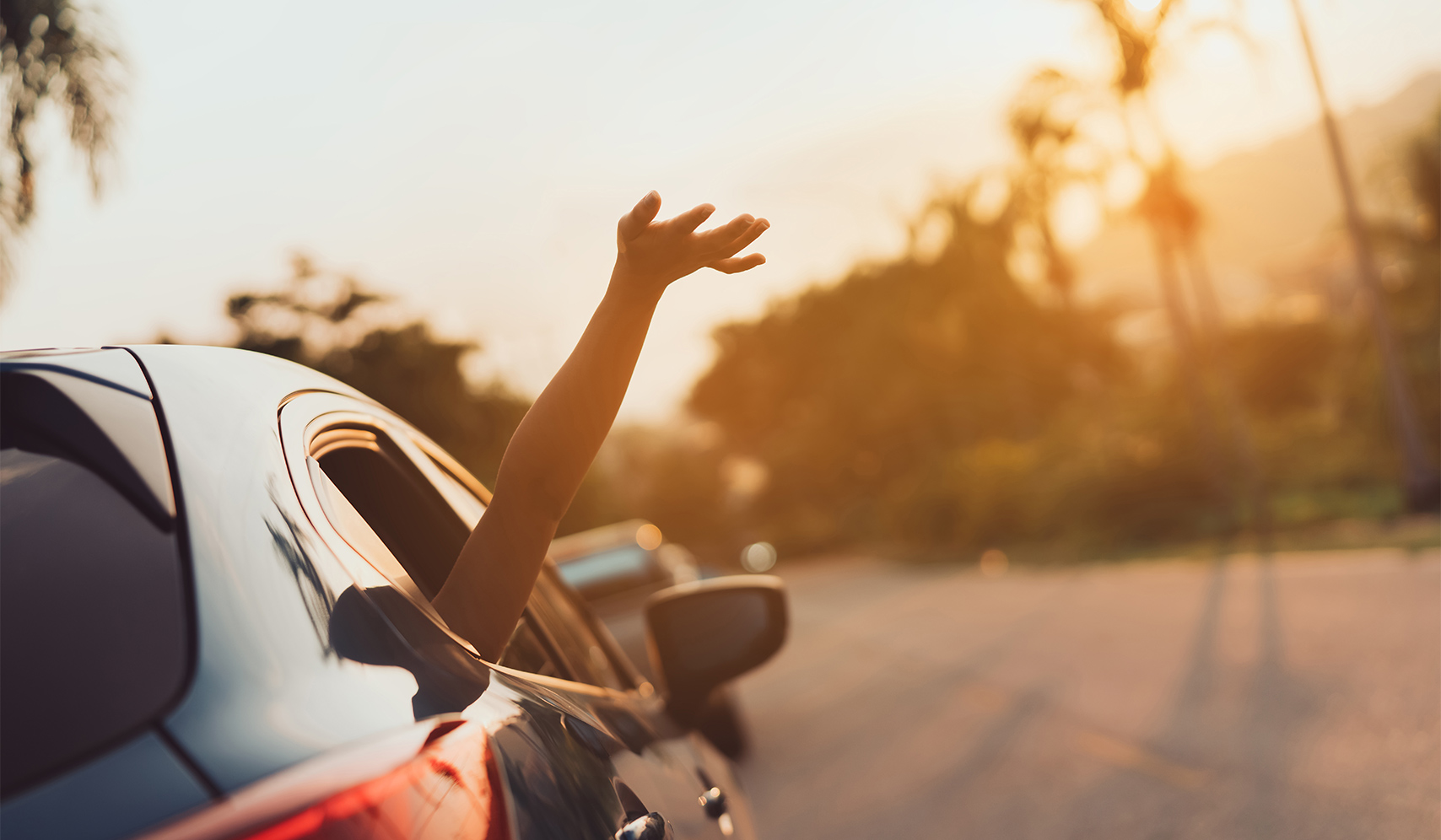 a person's arm out of a car window