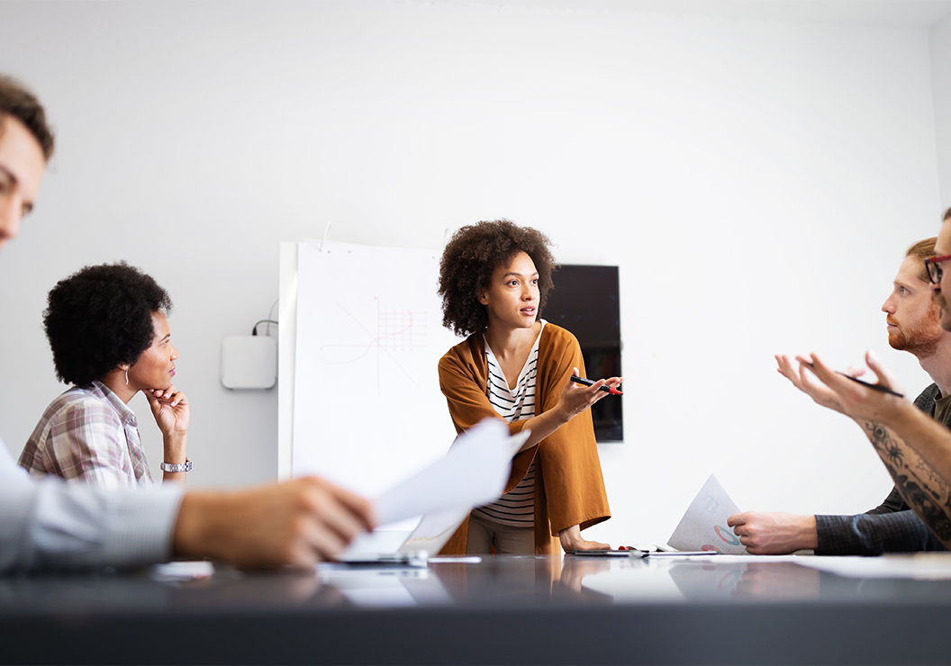 a woman standing in front of a group of people