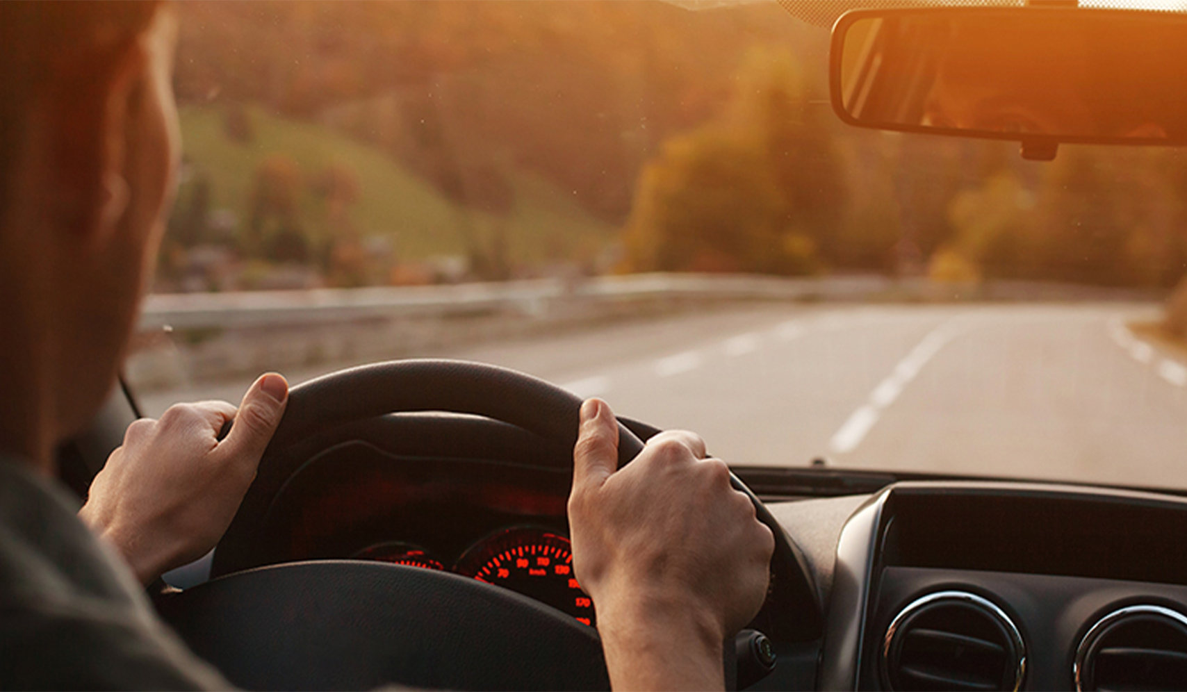hands on the steering wheel of a car