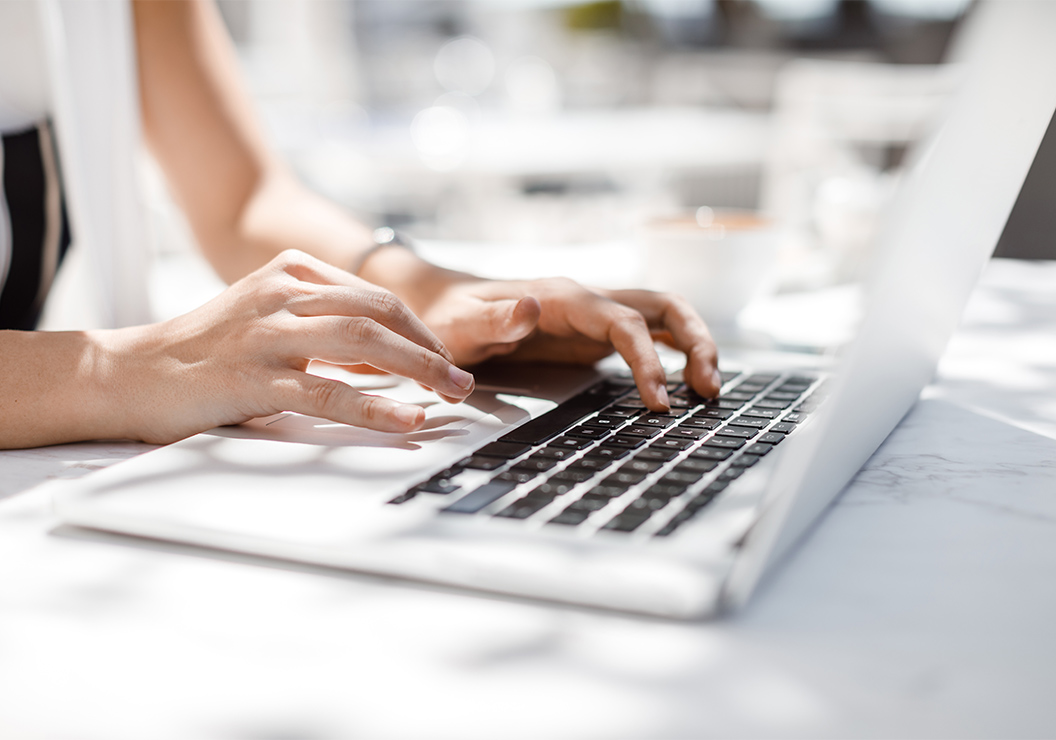 a person typing on a laptop