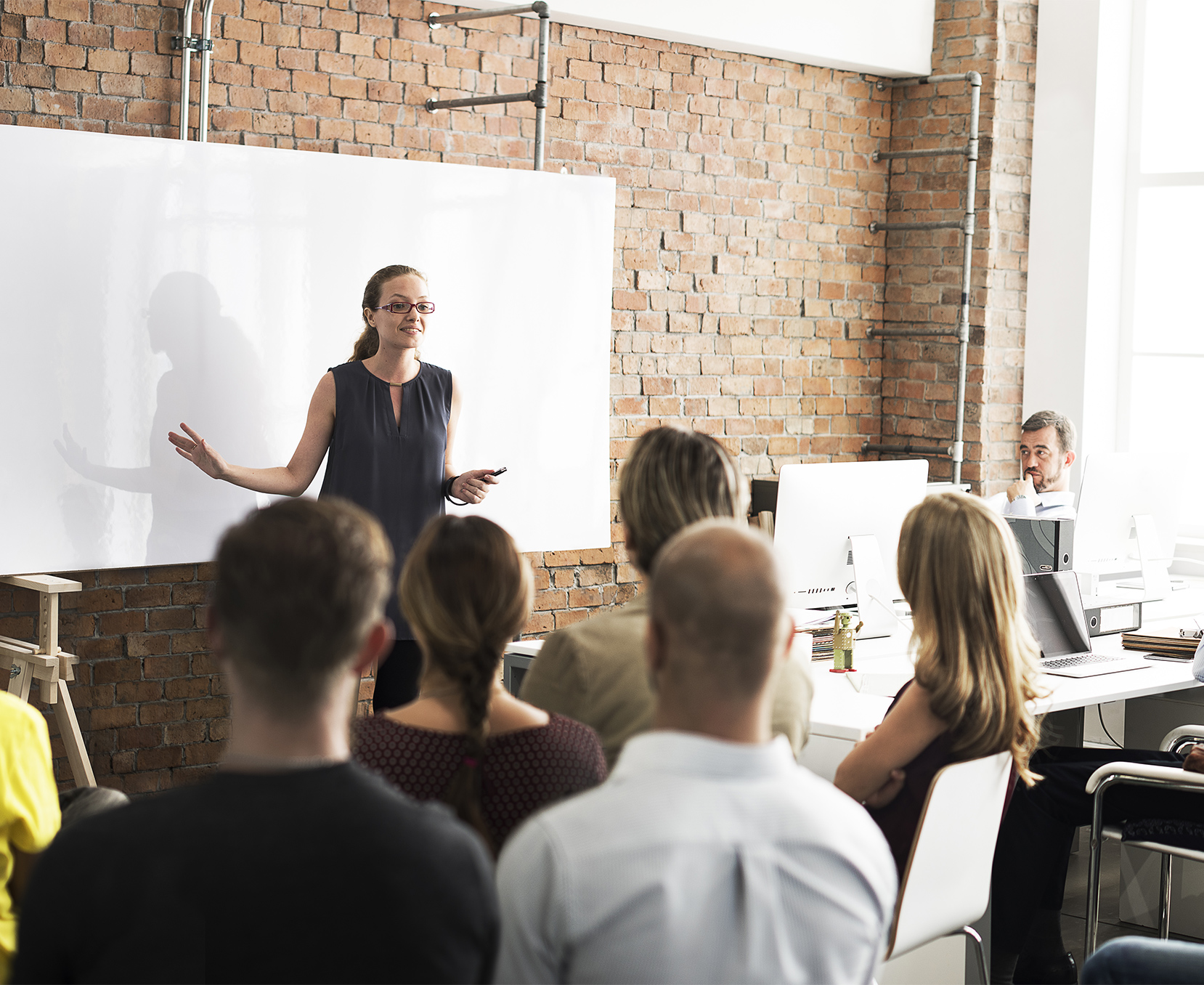 a woman standing in front of a group of people
