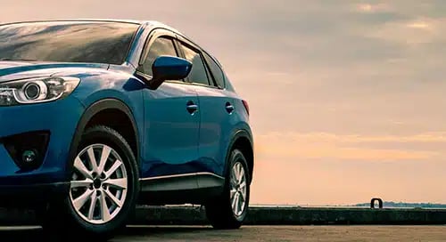 a blue car parked on a concrete surface