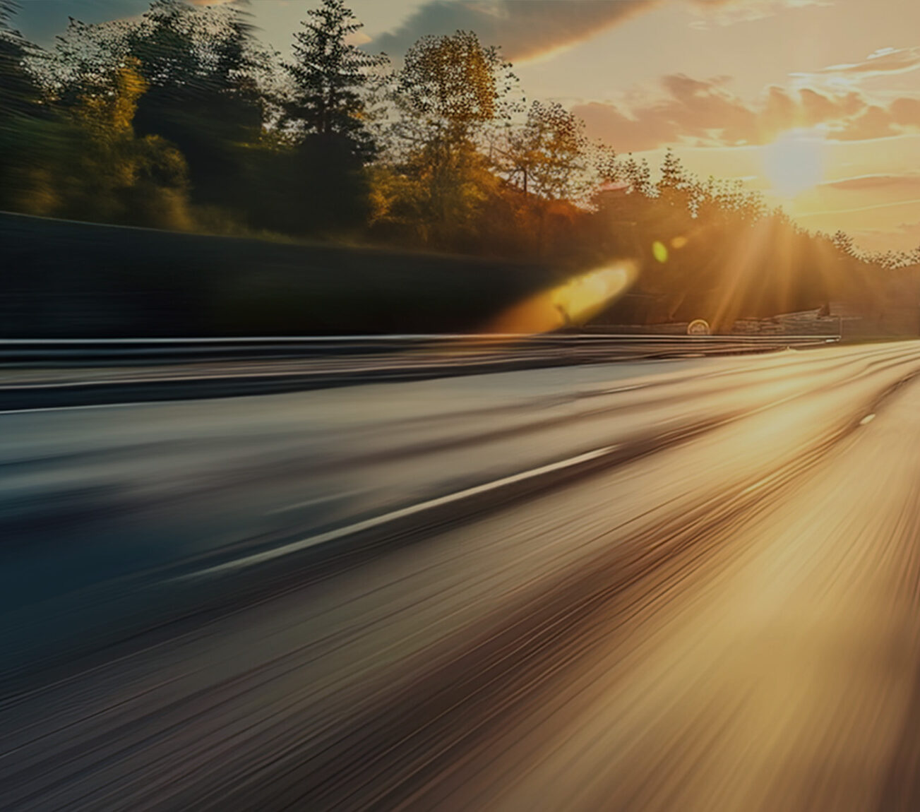 a blurry road with trees and sun