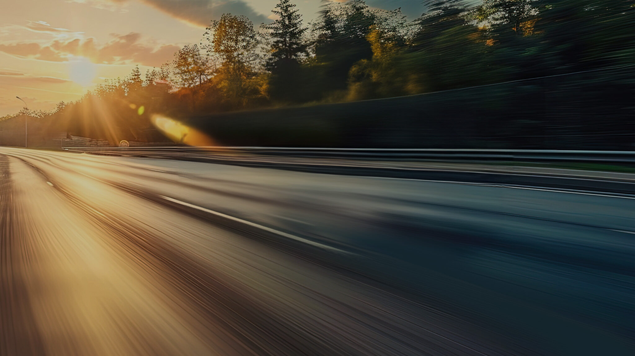 a blurry road with trees in the background