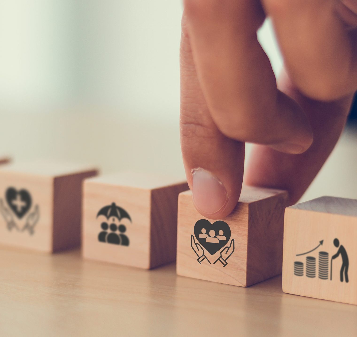 a finger touching a wooden block