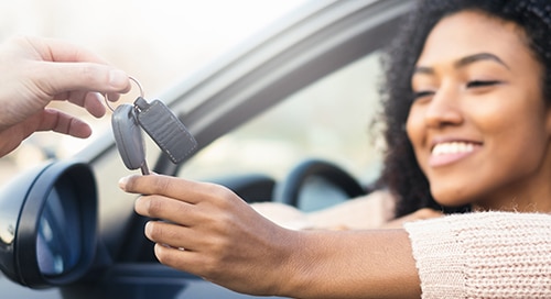 a woman holding a key in a car