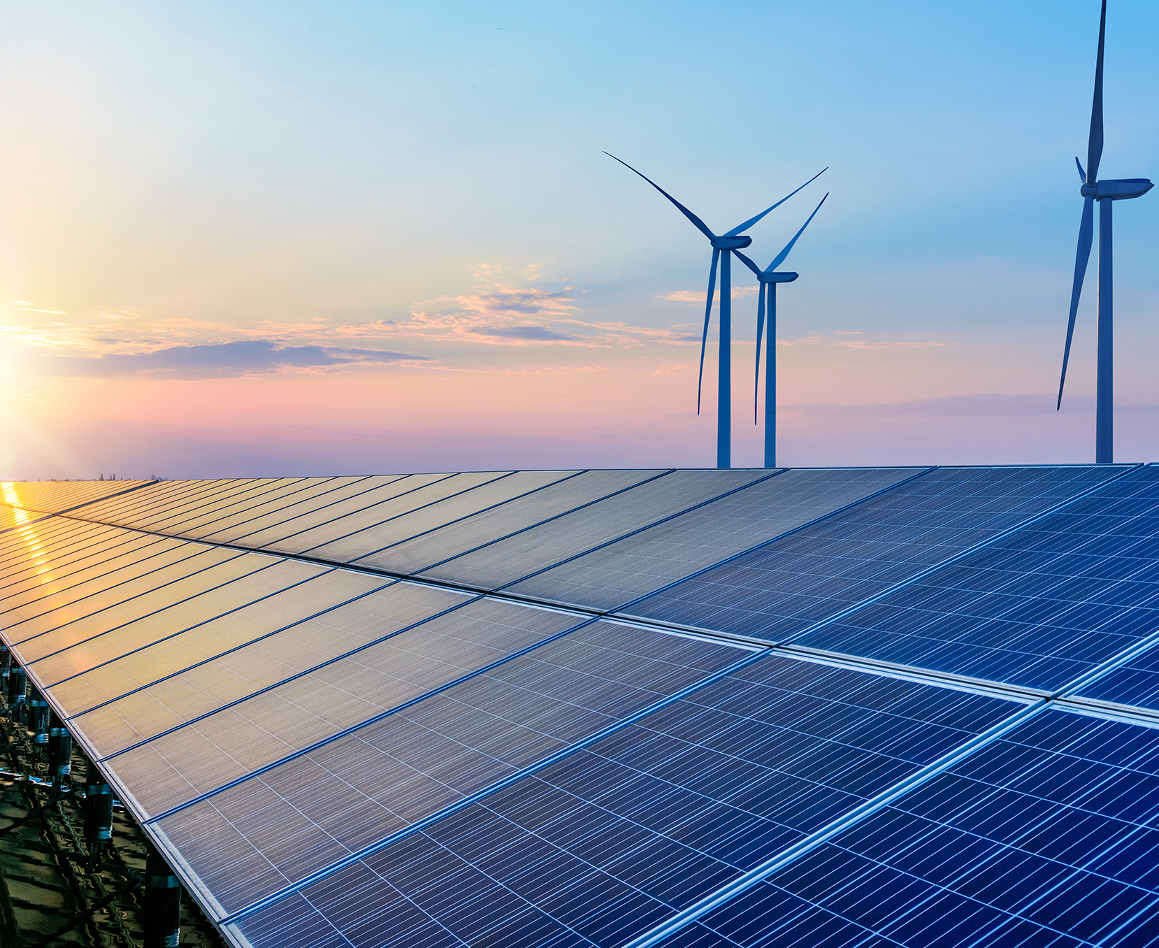 solar panels and wind turbines in a field