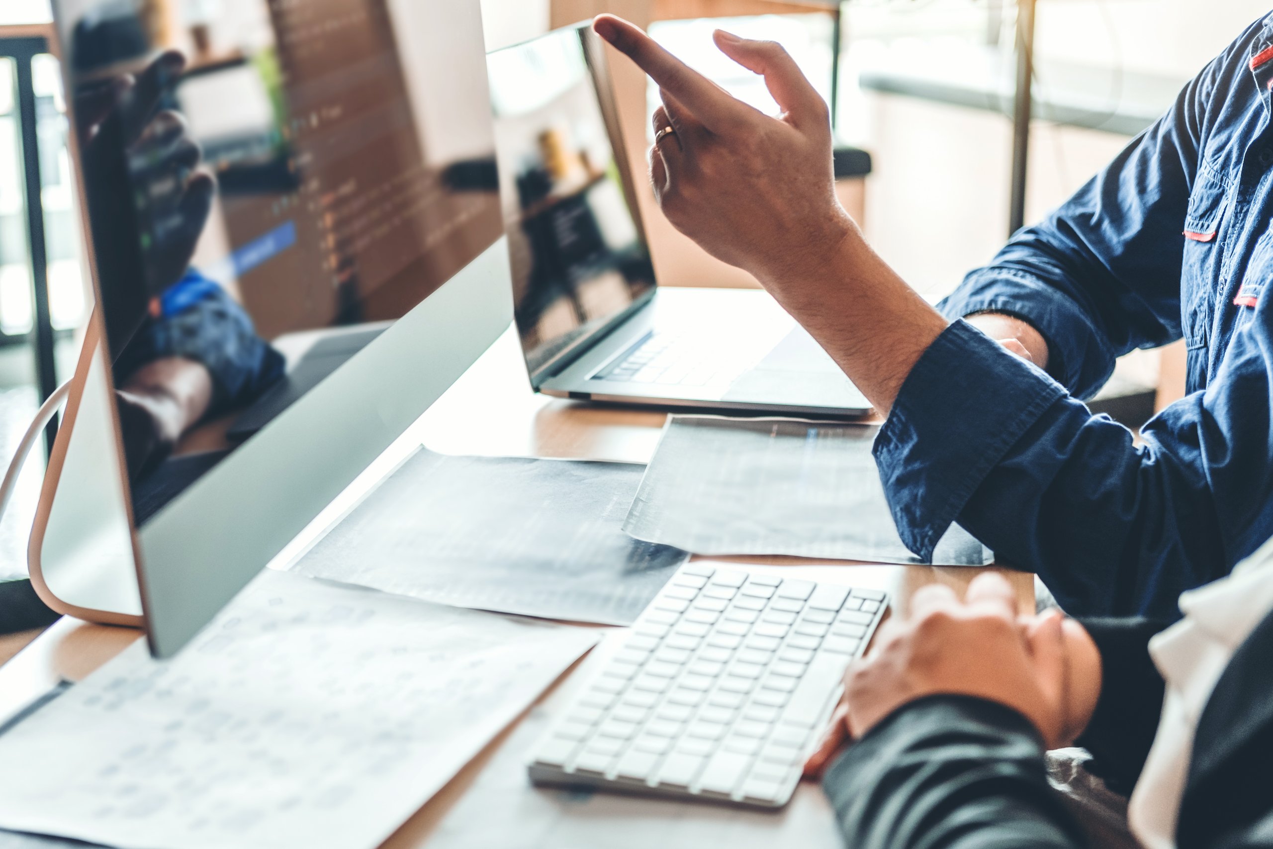 a man pointing at a computer screen