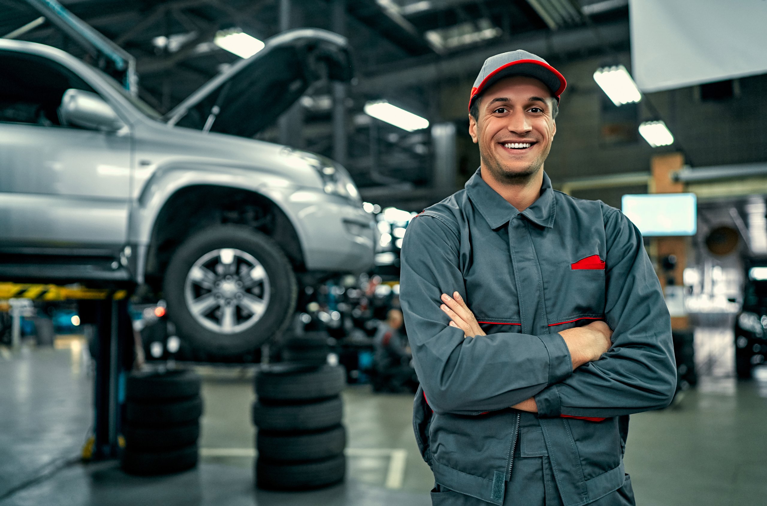 a man in a uniform standing in front of a car