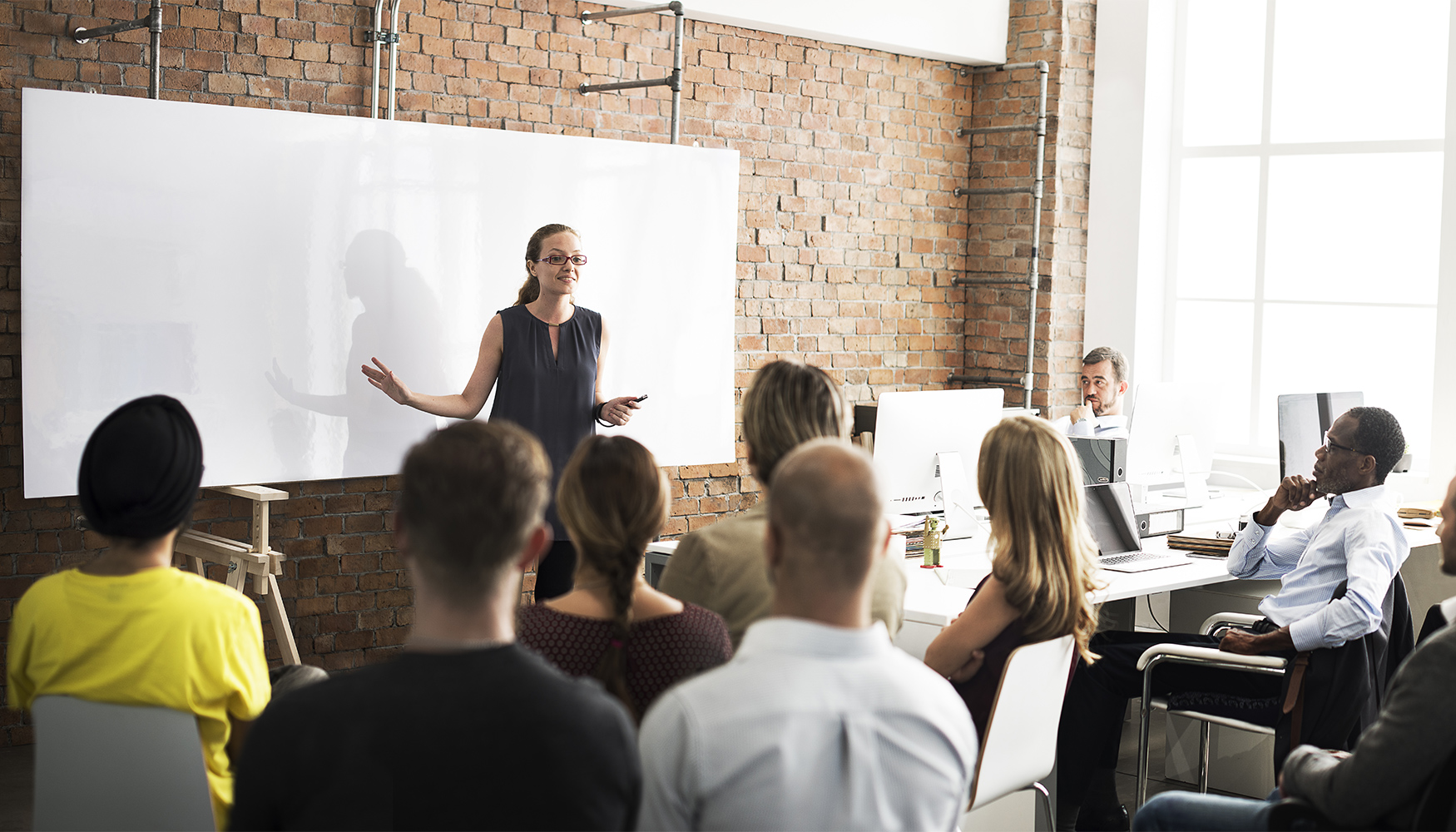 a woman standing in front of a group of people