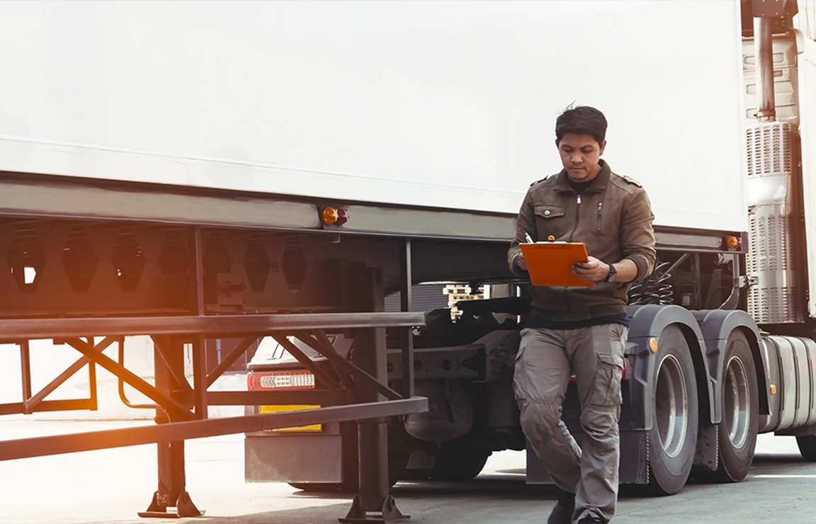 a man standing next to a truck