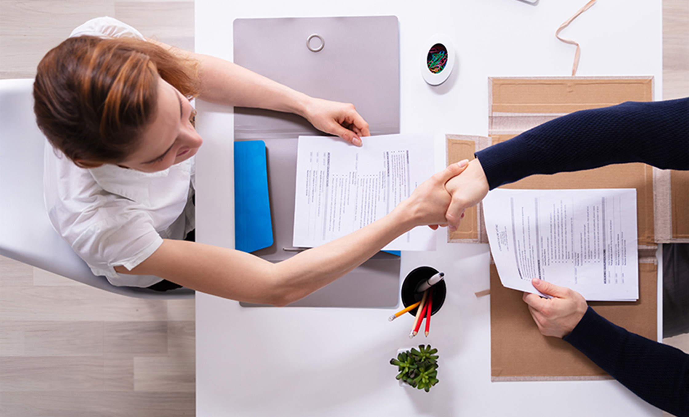 a woman shaking hands with another woman