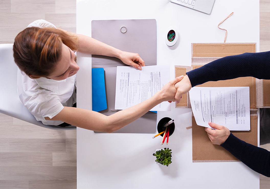 a woman shaking hands with another woman